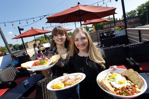BORIS MINKEVICH / WINNIPEG FREE PRESS General Manager Meghan Thiessen and assistant general manager Samara Pinto pose for a photo with some food at Stellas at 1463 Pembina (at Clarence). Photo taken on the rooftop patio. L-R  Baked eggs, French toast, and chorizo hash. Alison Gillmor review. June 28, 2016.