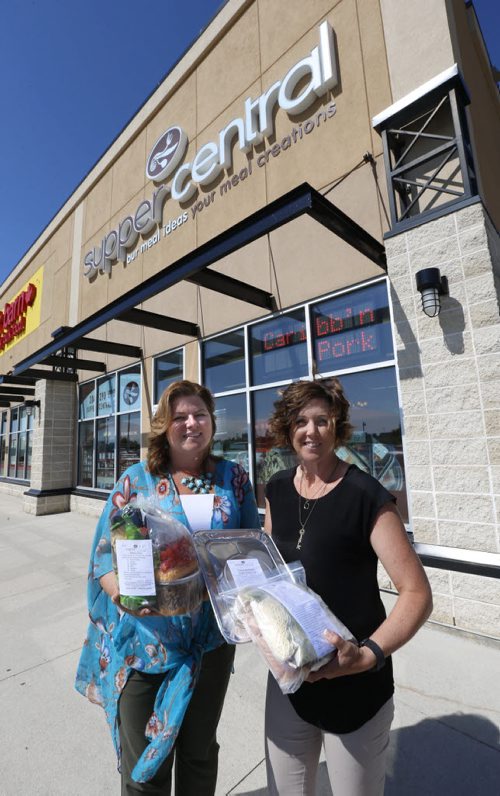 WAYNE GLOWACKI / WINNIPEG FREE PRESS      At right, Lori Vassart holds Bruschetta Pasta package and Hollow Mushroom Stuffed Burgers meals beside Crystal Anderson with Nacho Packs in front of their Supper Central in the Kenaston Common. Murray McNeill  Story June 28  2016