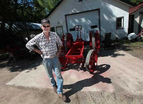 PHIL HOSSACK / WINNIPEG FREE PRESS - Barry Klym struts past the chassis of the1935 McCormick-Deering W-30 tractor he's re-building which will power another anitique a McCormick-Deering 22x38 threshing machine, he's taking the set to the Austin Thresherman's Reunion. - See Bill Redekop story. June 28, 2016