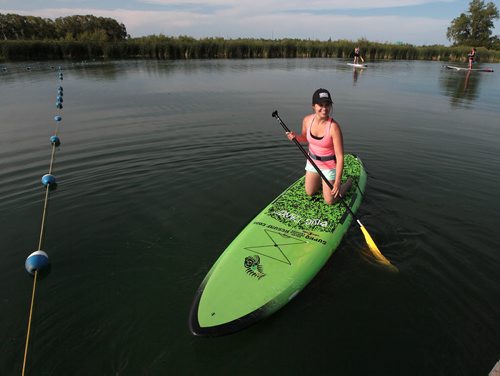 PHIL HOSSACK / WINNIPEG FREE PRESS -   Hardcore Surf and Paddleboard employee Raquel Saniuk sets out to help with a class of novices Tuesday evening. - See Dave Sanderson's  story. June 28, 2016