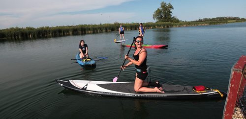 PHIL HOSSACK / WINNIPEG FREE PRESS -   Paddle Canada Paddle Board Instructor Dayna Fryza (front) sets out with a class of novices Tuesday evening. - See Dave Sanderson's  story. June 28, 2016