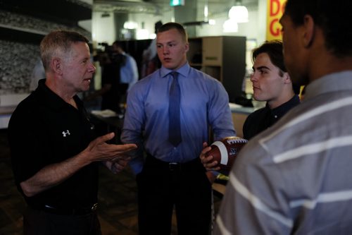 ZACHARY PRONG / WINNIPEG FREE PRESS  Brian Dobie, left, the head coach for the University of Manitoba's football team, talks to members of Team Manitoba at the Manitoba Sports Hall of Fame on June 29, 2016. Team Manitoba will be competing in the U18 Football Canada Cup and Dobie believes they are one of the strongest teams he's seen in years. From left to right, Brody Williams, Jake Richardson and Shae Weeks.