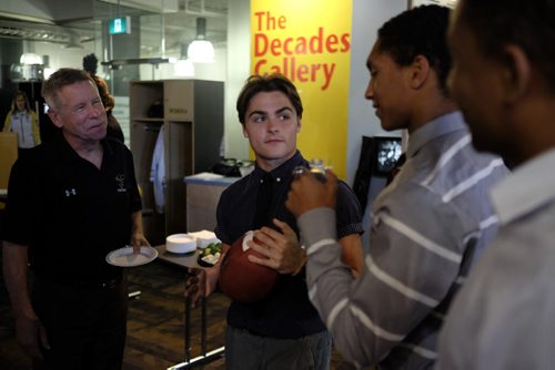 ZACHARY PRONG / WINNIPEG FREE PRESS  Brian Dobie, left, the head coach for the University of Manitoba's football team, talks to members of Team Manitoba at the Manitoba Sports Hall of Fame on June 29, 2016. Team Manitoba will be competing in the U18 Football Canada Cup and Dobie believes they are one of the strongest teams he's seen in years. From right to left, Remis Tshiovo, Shae Weekes and Jake Richardson.
