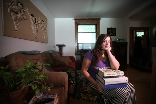 RUTH BONNEVILLE / WINNIPEG FREE PRESS  Lauren Henderson sits with her textbooks from her midwifery program that she was in this past year in hopes of graduating in 2019 until being told Monday that the program is now cancelled.   See Jen Zoratti story.   June 29 / 2016