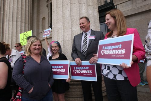 JOE BRYKSA / WINNIPEG FREE PRESS  About 100 people attended a protest in support of Manitoba midwifery students- PC Mlas Sarah Guillemard- Fort Richmond, right,  and Len Isleifson- Brandon East, next to Guillemard in suit at rally  -June 30, 2016  -(See Nick Martin story)