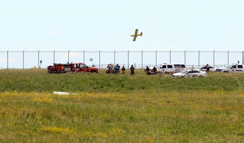 Ruth Bonneville / Winnipeg Free Press   Rescue are at the scene of a small plane that crashed just north of Number one highway, east of the floodway Friday morning. It took off from Lyncrest Airport earlier in the day with two people on board. Both are presumed to have died in the crash.  No other details are available at this time. A plane is seen flying over the area most likely being from Lyncrest Airport in area.      July 01/2016