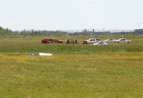 Ruth Bonneville / Winnipeg Free Press   Rescue crews at the scene of a small plane that crashed just north of Number one highway, east of the floodway Friday morning.  It took off from Lyncrest Airport earlier in the day with two people on board.  Both are presumed to have died in the crash.  No other details are available at this time.      July 01/2016