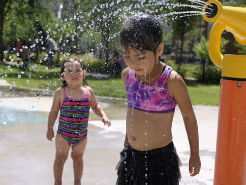 ZACHARY PRONG / WINNIPEG FREE PRESS  Meadow, 4, and her sister Jazmine, 2, cool off at the splash park on Cumberland on July 2, 2016.