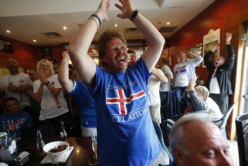 JOHN WOODS / WINNIPEG FREE PRESS Shawn Bjornsson and Iceland fans at the Lakeview Hotel in Gimli cheer as their team scores on  France in the Euro Cup Sunday, July 3, 2016.