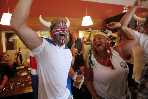JOHN WOODS / WINNIPEG FREE PRESS Iceland fans Kristinn Traustason and Tracy Martin at the Lakeview Hotel in Gimli cheer as their team scores on  France in the Euro Cup Sunday, July 3, 2016.