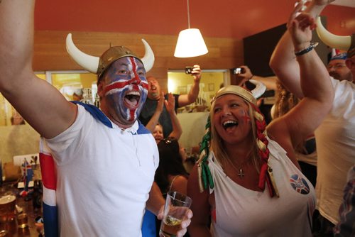 JOHN WOODS / WINNIPEG FREE PRESS Iceland fans Kristinn Traustason and Tracy Martin at the Lakeview Hotel in Gimli cheer as their team scores on  France in the Euro Cup Sunday, July 3, 2016.