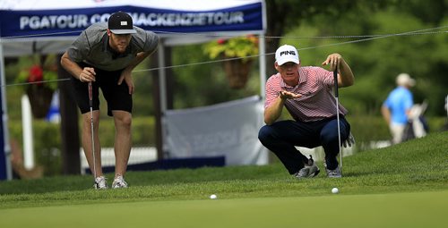 PHIL HOSSACK / WINNIPEG FREE PRESS - Pro to Pro - PGA tour pro Will McCurdy (right) of Auburn Alabama explains the lay of the green to the newest Winnipeg Jet, Quinton Howden before putting on the 18th Green at Niakwa Golf and Country Club Monday in the Pro am event at the Players Cup. Quinton is origionally from Oak Bank. (See File shot taken when he was 15 taken in his home there.) See Mike MacIntyre's story. July 4, 2016