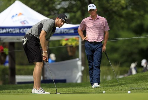 PHIL HOSSACK / WINNIPEG FREE PRESS - Pro to Pro - PGA tour pro Will McCurdy (right) of Auburn Alabama watches as the newest Winnipeg Jet, Quinton Howden putts on the 18th Green at Niakwa Golf and Country Club Monday in the Pro am event at the Players Cup. Quinton is origionally from Oak Bank. (See File shot taken when he was 15 taken in his home there.) See Mike MacIntyre's story. July 4, 2016