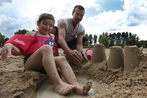 JOHN WOODS / WINNIPEG FREE PRESS Darren Ellison and his daughter Blessing spent the day at Birds Hill Park building sandcastles and swimming at the beach Monday, July 4, 2016.