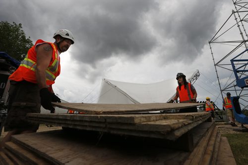 JOHN WOODS / WINNIPEG FREE PRESS David Allston and Melanie Lemoine move staging in preparation for next weekend's Folk Fest Monday, July 4, 2016.