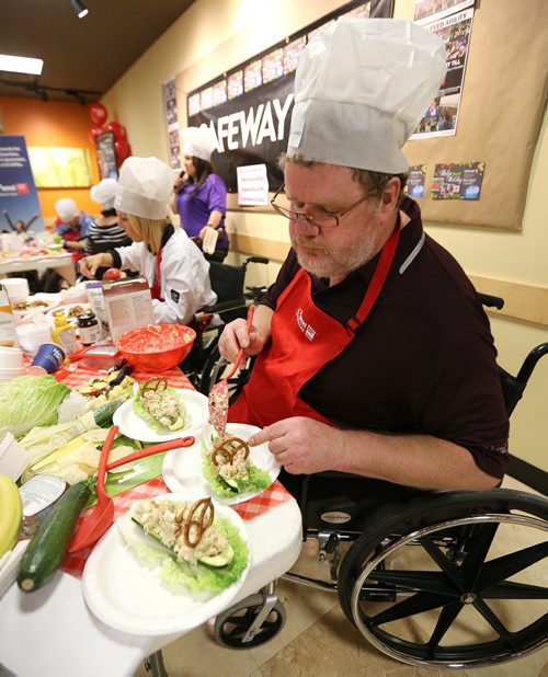 JASON HALSTEAD / WINNIPEG FREE PRESS  Winnipeg Free Press columnist Doug Speirs puts the finishing touches on his first-place winning dish at the Society for Manitobans with Disabilities (SMD)/Easter Seals Manitoba Celebrity Cook-Off for Kids competition during the 2016 Safeway Campaign Launch at Madison Square Safeway on June 29, 2016. Local media celebrities navigated a competition kitchen in wheelchairs to prepare camp-themed dishes for a panel of three judges. (See Social Page)