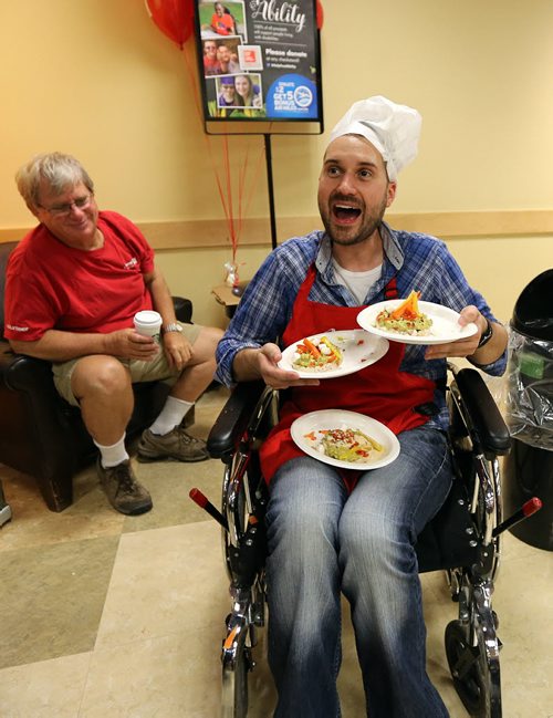 JASON HALSTEAD / WINNIPEG FREE PRESS  Drew Kozub (KISS 102.3) takes his dish to the judges at the Society for Manitobans with Disabilities (SMD)/Easter Seals Manitoba Celebrity Cook-Off for Kids competition during the 2016 Safeway Campaign Launch at Madison Square Safeway on June 29, 2016. Local media celebrities navigated a competition kitchen in wheelchairs to prepare camp-themed dishes for a panel of three judges. (See Social Page)