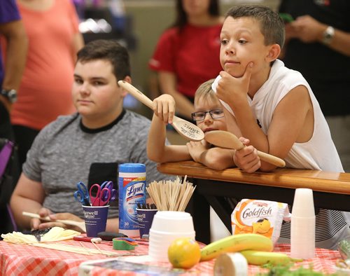 JASON HALSTEAD / WINNIPEG FREE PRESS  L-R: Society for Manitobans with Disabilities (SMD)/Easter Seals Manitoba youth ambassador Spencer Lambert, 15, Drayson Day, 7, and his brother Nolan Day, 10, watch the action at the Celebrity Cook-Off for Kids competition during the 2016 Safeway Campaign Launch at Madison Square Safeway on June 29, 2016. Local media celebrities navigated a competition kitchen in wheelchairs to prepare camp-themed dishes for a panel of three judges. (See Social Page)