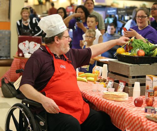 JASON HALSTEAD / WINNIPEG FREE PRESS  Winnipeg Free Press columnist Doug Speirs selects more ingredients at the Society for Manitobans with Disabilities (SMD)/Easter Seals Manitoba Celebrity Cook-Off for Kids competition during the 2016 Safeway Campaign Launch at Madison Square Safeway on June 29, 2016. Local media celebrities navigated a competition kitchen in wheelchairs to prepare camp-themed dishes for a panel of three judges. (See Social Page)