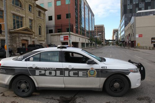 JOE BRYKSA / WINNIPEG FREE PRESS Police are tight lipped about a investigation they are doing in downtown Winnipeg Tuesday morning-That investigation has seen police close Portage Ave in both direction between Hargrave St and Donald St, and close Donald between Ellice and Portage Ave- Police  block Donald St at Ellice near 7 am -July 05, 2016  -(Breaking News- See Redekop story)