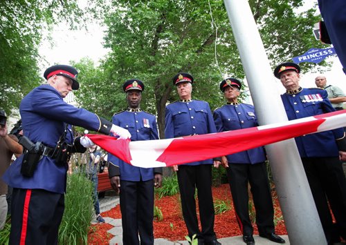 RUTH BONNEVILLE / WINNIPEG FREE PRESS  Winnipeg Police Constable Tanasychuk folds up the Canadian Flag as Winnipeg Police Chief Devon Clunis and past police chiefs, Keith McCaskill (right of Clunis), Jack Ewatski and Herb Stephen look on at   ceremony to bid Farewell to the old police head quarters on Princess Tuesday.  On July 5th, the doors to the Public Safety Building will officially close for good.    July 05, 2016