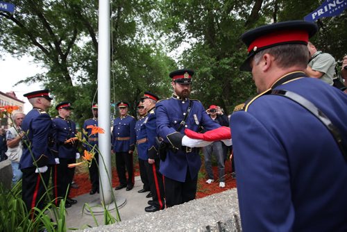 RUTH BONNEVILLE / WINNIPEG FREE PRESS  Winnipeg Police Constable, Bourque, hands folded flag over to fellow Constable after it was lowered for the last time bidding farewell to the old police headquarters on Princess St. Tuesday.  Police Chief Devon Clunis and past police chiefs, Keith McCaskill (right of Clunis), Jack Ewatski and Herb Stephen look on at  ceremony.  On July 5th, the doors to the Public Safety Building will officially close for good.    July 05, 2016