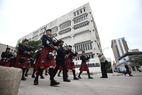 RUTH BONNEVILLE / WINNIPEG FREE PRESS  The Winnipeg Police Pipe Band make their way up from the lower level of the PSB building onto William Ave. during ceremony to bid farewell to the old police headquarters Tuesday.   On July 5th, the doors to the Public Safety Building will officially close.  July 05, 2016