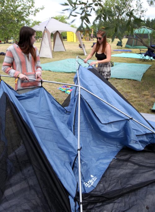 JOE BRYKSA / WINNIPEG FREE PRESS Campers arrive at their campsites to kick off the 2016 Winnipeg Folk Fest at Birds Hill Park Wednesday morning- L to R- Kialey Schur, and her friend Alysha Guenther set up their tent on festival grounds. Festival music starts tomorrow and will run until July 10-July 06, 2016  -(Standup Photo)