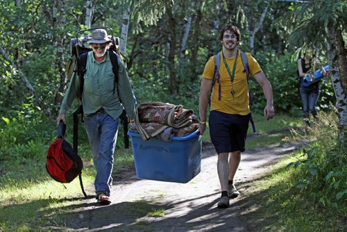 JOE BRYKSA / WINNIPEG FREE PRESS Campers arrive at their campsites to kick off the 2016 Winnipeg Folk Fest at Birds Hill Park Wednesday morning- L to R- Tim White from- Wisconsin and Simo Devine pitch in to carry gear into camp site. Festival music starts tomorrow and will run until July 10-July 06, 2016  -(Standup Photo)