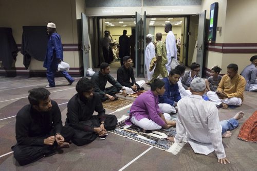 ZACHARY PRONG / WINNIPEG FREE PRESS  Men relax after prayers at the RBC Convention Centre where thousands of people gathered for Eid celebrations on July 6, 2016. Eid marks the end of the Muslim holy month of Ramadan.