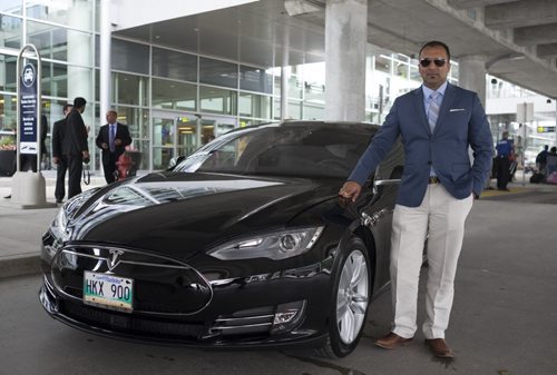 ZACHARY PRONG / WINNIPEG FREE PRESS  Ricky Brar, the president of Hollywood Limousine Service Inc., next to the company's newest addition to its fleet; a Tesla Model S. July 6, 2016.