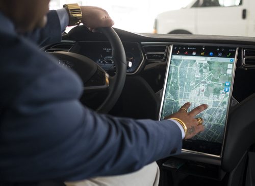 ZACHARY PRONG / WINNIPEG FREE PRESS  Ricky Brar, the president of Hollywood Limousine Service Inc., inside the company's newest addition to its fleet; a Tesla Model S. July 6, 2016.