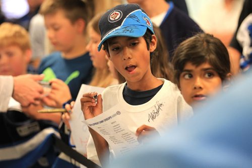 RUTH BONNEVILLE / WINNIPEG FREE PRESS  Young hockey fans wait patiently along walkway for hockey players to finish up practicing on ice in the Winnipeg Jets Development Camp at IcePlex Wednesday morning.  General photo, no specific names. Possible standup photo.       July 06, 2016