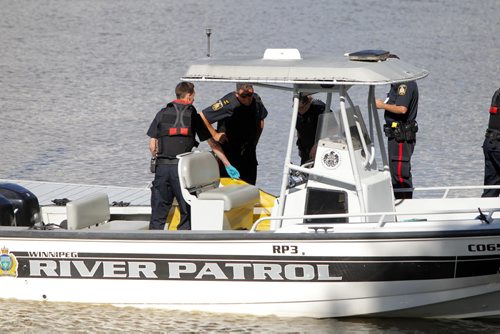 BORIS MINKEVICH / WINNIPEG FREE PRESS Police with yellow body bag in Police boat at St. Vital Park boat launch.  July 6, 2016