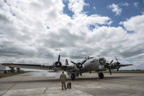 DAVID LIPNOWSKI / WINNIPEG FREE PRESS Crew Chief Craig Bartscht from Fort Wayne , Indiana checks over the engines of a Boeing B-17 Bomber (Flying Fortress) prior to takeoff from the Gimli Airport Wednesday July 6, 2016. The World War 2 era plane is one of only 13 aircraft of its type still flying.