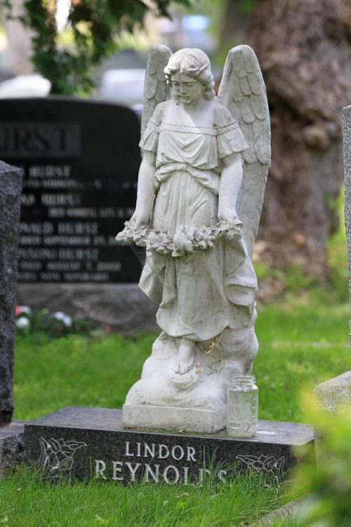 RUTH BONNEVILLE / WINNIPEG FREE PRESS  Photos of  deceased FP columnist Lindor Reynolds Stone Angel headstone at St. John's Cathedral Cemetery, at 135 Anderson Avenue. WHAT: A tour of the historic Cathedral and cemetery. This is for a signature piece on the St. John's Cathedral Cemetery, for a series on cemeteries.  WHO: Tour giver is named Rene Jamieson who gives tours on some of the most noteworthy gravestones.  See Bill Redekop's story.   July 06, 2016