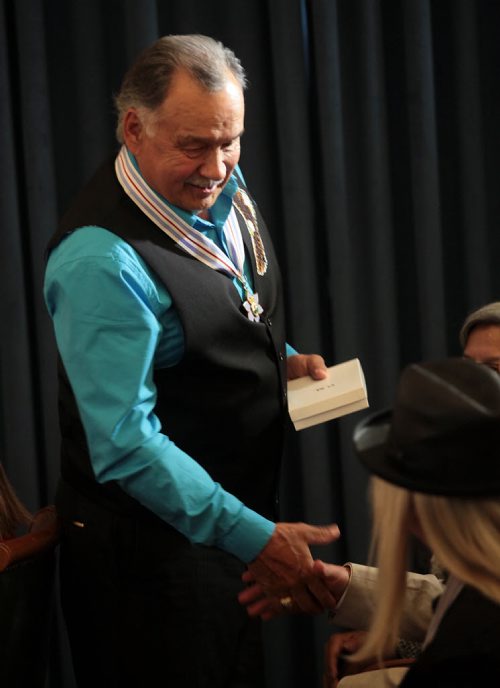 PHIL HOSSACK / WINNIPEG FREE PRESS - Regie Leach O.M. reaches out to accept the congratulations of fellow recipients Thursday at the Mb Legislature as he and ten others were presented with the Order of Manitoba. See story. July 7, 2016