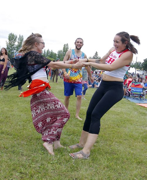 BORIS MINKEVICH / WINNIPEG FREE PRESS WINNIPEG FOLK FESTIVAL 2016 - Some friends enjoy some dance near the Main Stage Thursday evening. Woman wearing glasses/skirt is Hailley Fayle form Fredericton, NB and the woman with black pants is Ashley Wanlan form Winnipeg. No other IDs for anyone else in the background.  July 7, 2016