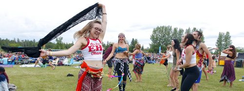 BORIS MINKEVICH / WINNIPEG FREE PRESS WINNIPEG FOLK FESTIVAL 2016 - Some friends enjoy some dance near the Main Stage Thursday evening. Woman wearing glasses/skirt is Hailley Fayle form Fredericton, NB and the woman with black pants is Ashley Wanlan form Winnipeg. No other IDs for anyone else in the background.  July 7, 2016