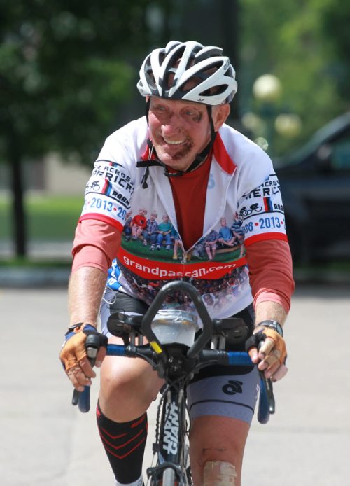 RUTH BONNEVILLE / WINNIPEG FREE PRESS Extreme cyclist Arvid Loewen who holds a Guinness World Record for his speed cycling across Canada, makes his way to the front of the Legislative Building Friday afternoon where friends and family are gathered to greet him. He made a quick stop in Winnipeg on his way to Halifax to break his own record travelling 6040km from Vancouver to Halifax. The Winnipeg Grandpa, who turns 60 this year, Is raising funds for the Mully Children's Family Charity. He still has scrapes and bruises from a fall he took early in the race. See Alex Paul story. July 08, 2016