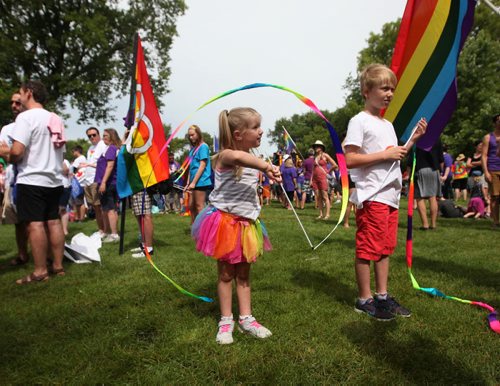 RUTH BONNEVILLE / WINNIPEG FREE PRESS  Four-year-old Ava Toews swirls a rainbow banner around her while attending Steinbach's 1st ever Pride march Saturday with family.    July 09, 2016