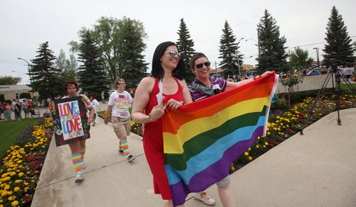 RUTH BONNEVILLE / WINNIPEG FREE PRESS  Michelle McHale and her partner Karen Phillips make their way up the steps city hall in Steinbach as thousands of supporters gather behind them at to celebrate Steinbach's 1st ever Pride march Saturday.   July 09, 2016