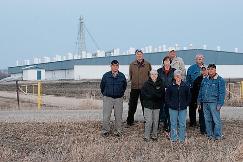 BORIS MINKEVICH / WINNIPEG FREE PRESS 080417 Bill Massey , far right, is part of a group that does not like the hog barn in their Grosse Isle community. They pose for a photo with the hog barn behind them.