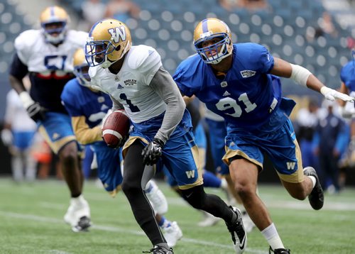 TREVOR HAGAN / WINNIPEG FREE PRESS Winnipeg Blue Bombers Adrian Hubbard, 91, chases Jace Davis, 1, during practice, Sunday, July 10, 2016.