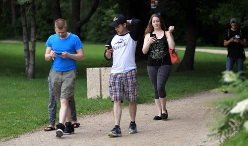 PHIL HOSSACK / WINNIPEG FREE PRESS - Heads down and silent, Pokemon fans rallied a hundred or so strong  at the Oodena Circle. See Alex dePape's story. July 11, 2016