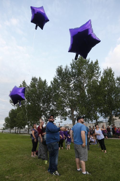 JOHN WOODS / WINNIPEG FREE PRESS Family and friends release balloons at a vigil for Thelma Krull at Civic Park Monday, July 11, 2016.
