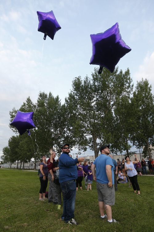 JOHN WOODS / WINNIPEG FREE PRESS Family and friends release balloons at a vigil for Thelma Krull at Civic Park Monday, July 11, 2016.