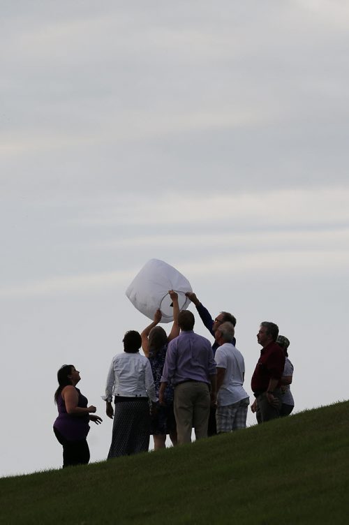 JOHN WOODS / WINNIPEG FREE PRESS Family gathers at the top of a hill to release a floating lantern during a vigil for Thelma Krull at Civic Park Monday, July 11, 2016.