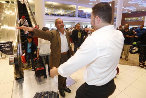 JOHN WOODS / WINNIPEG FREE PRESS Khudher Naso and his family are greeted by family and supporters at the Winnipeg airport Monday, July 11, 2016. The Yazidis families arrived from Turkey.
