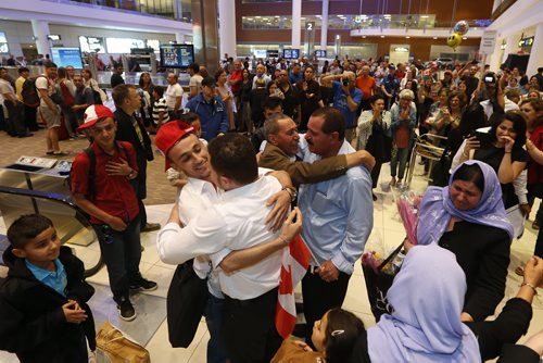JOHN WOODS / WINNIPEG FREE PRESS Khudher Naso, Munifa Hussein and their family are greeted by family and supporters at the Winnipeg airport Monday, July 11, 2016. The Yazidis families arrived from Turkey.